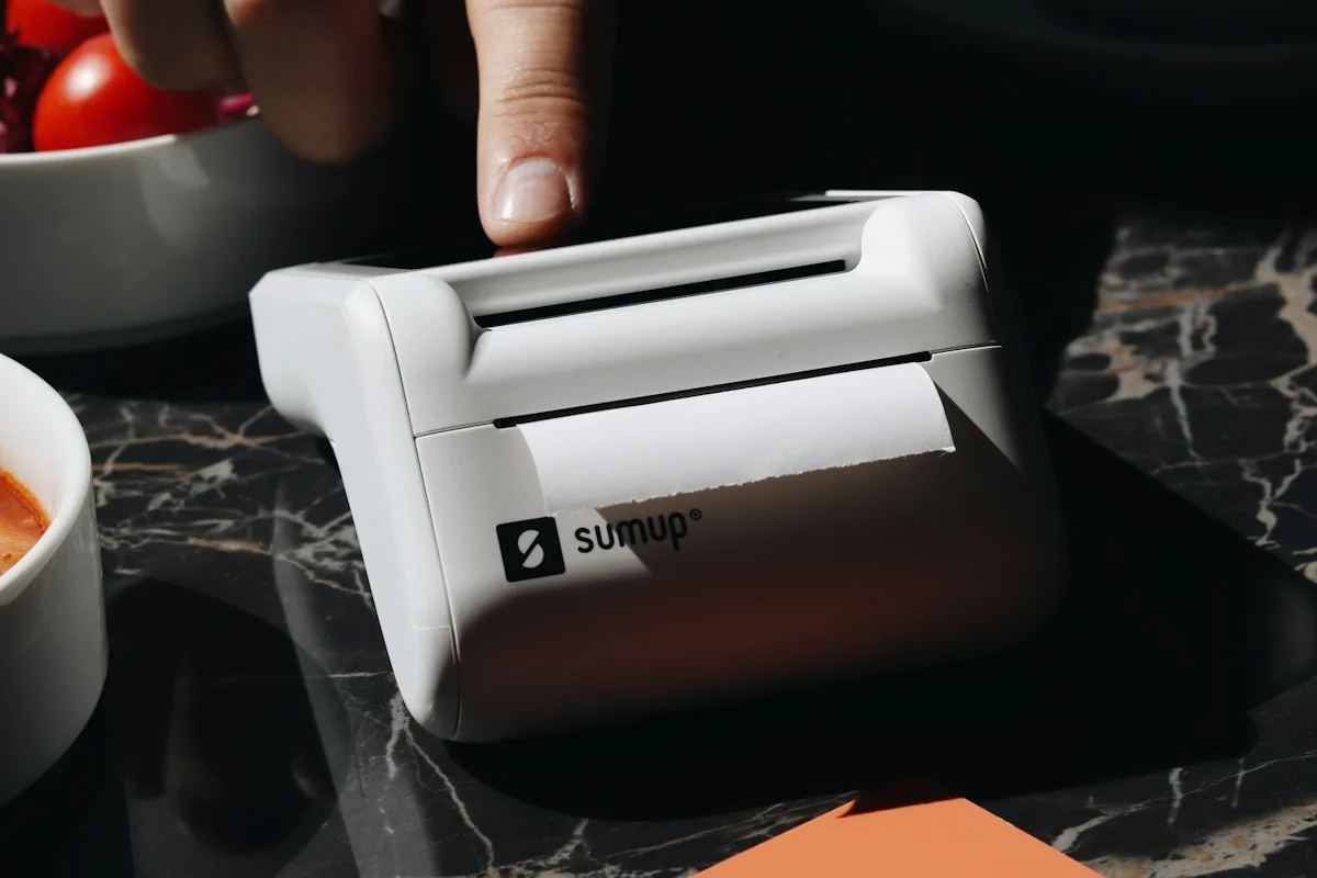 Digital nomad comparing Revolut vs Wise multi currency cards on cafe table