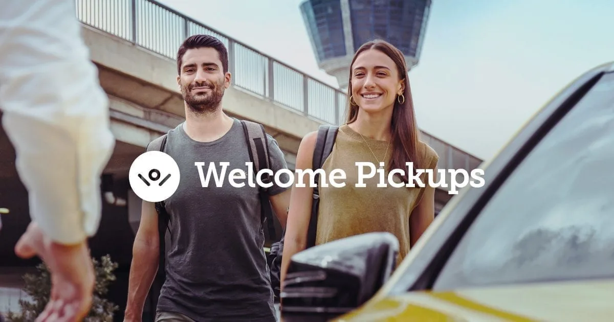 Welcome Pickups premium airport transfer driver meeting traveler at arrival