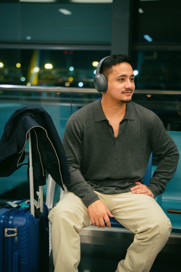 Person wearing noise cancelling headphones while traveling at an airport