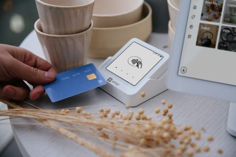 Person paying with a card at a point-of-sale terminal while traveling