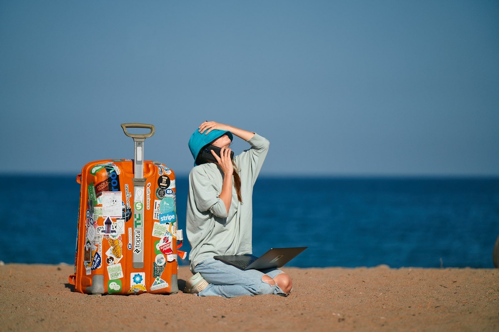 Digital nomad traveling with laptop, representing travel health insurance coverage