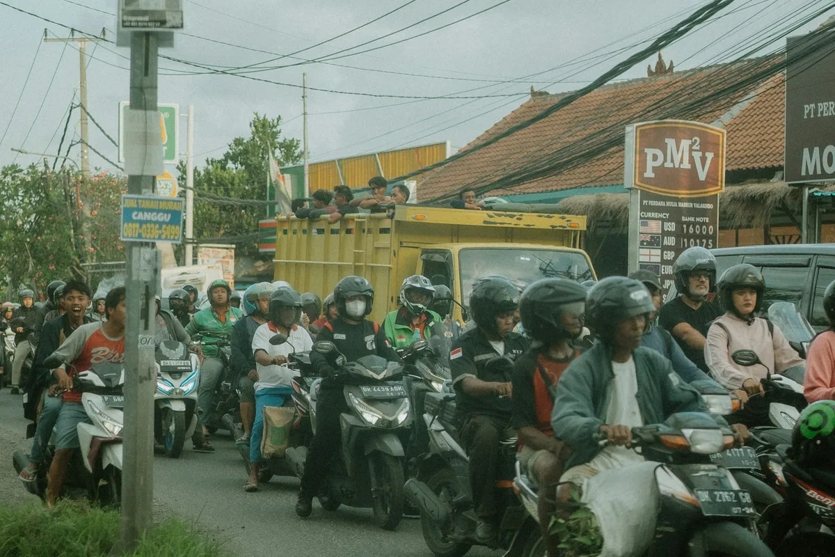Rows of scooters in rush hour traffic on a street in Bali