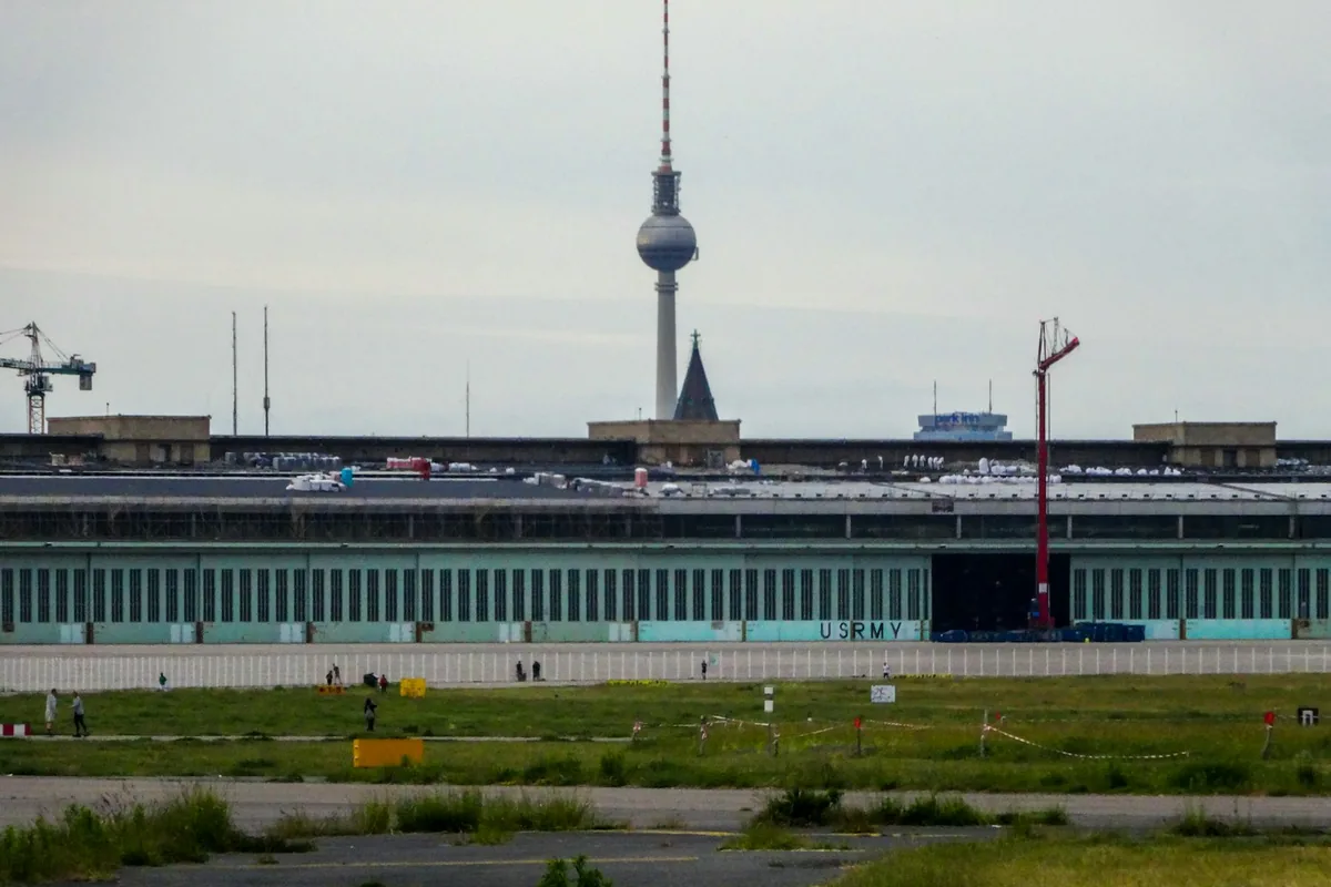 Modern BER airport terminal with the Berlin TV tower in the background