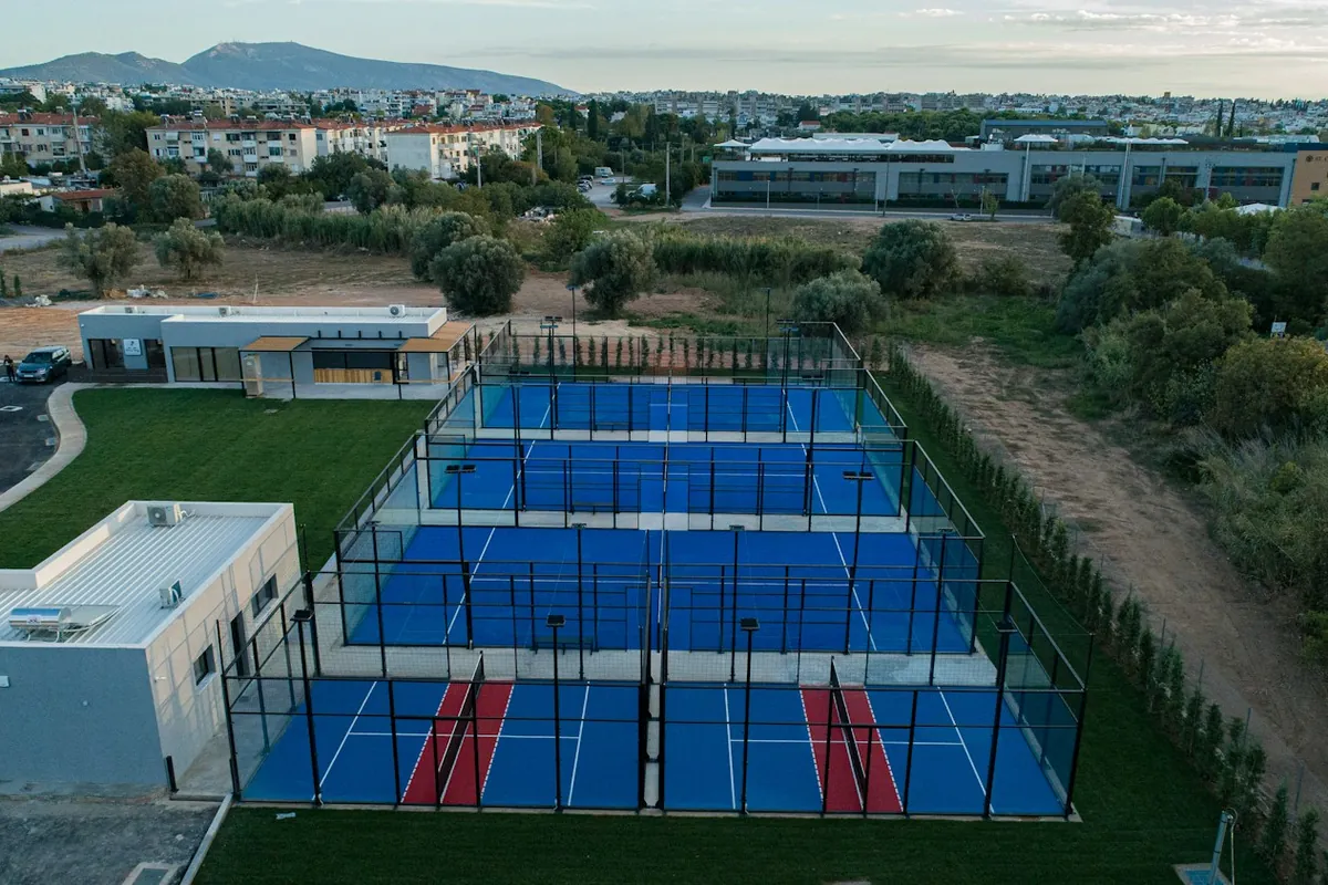 Aerial view of a padel club with several blue courts