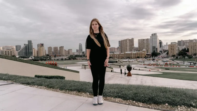 Young woman traveling solo standing in front of a city skyline