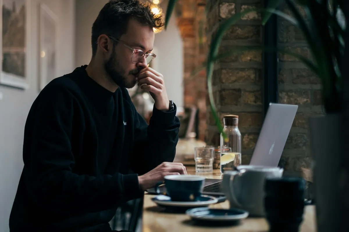 Freelancer working on a laptop in a coffee shop