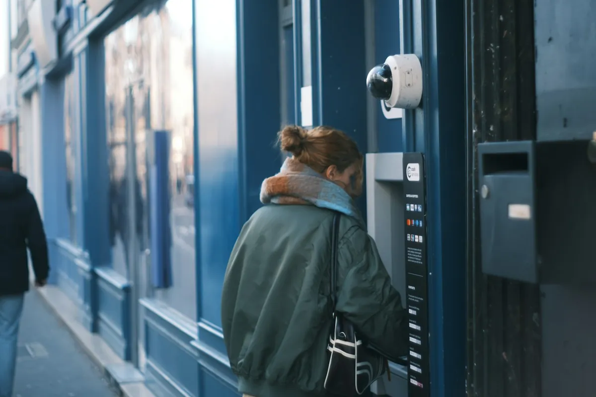 Traveler withdrawing cash from a street ATM
