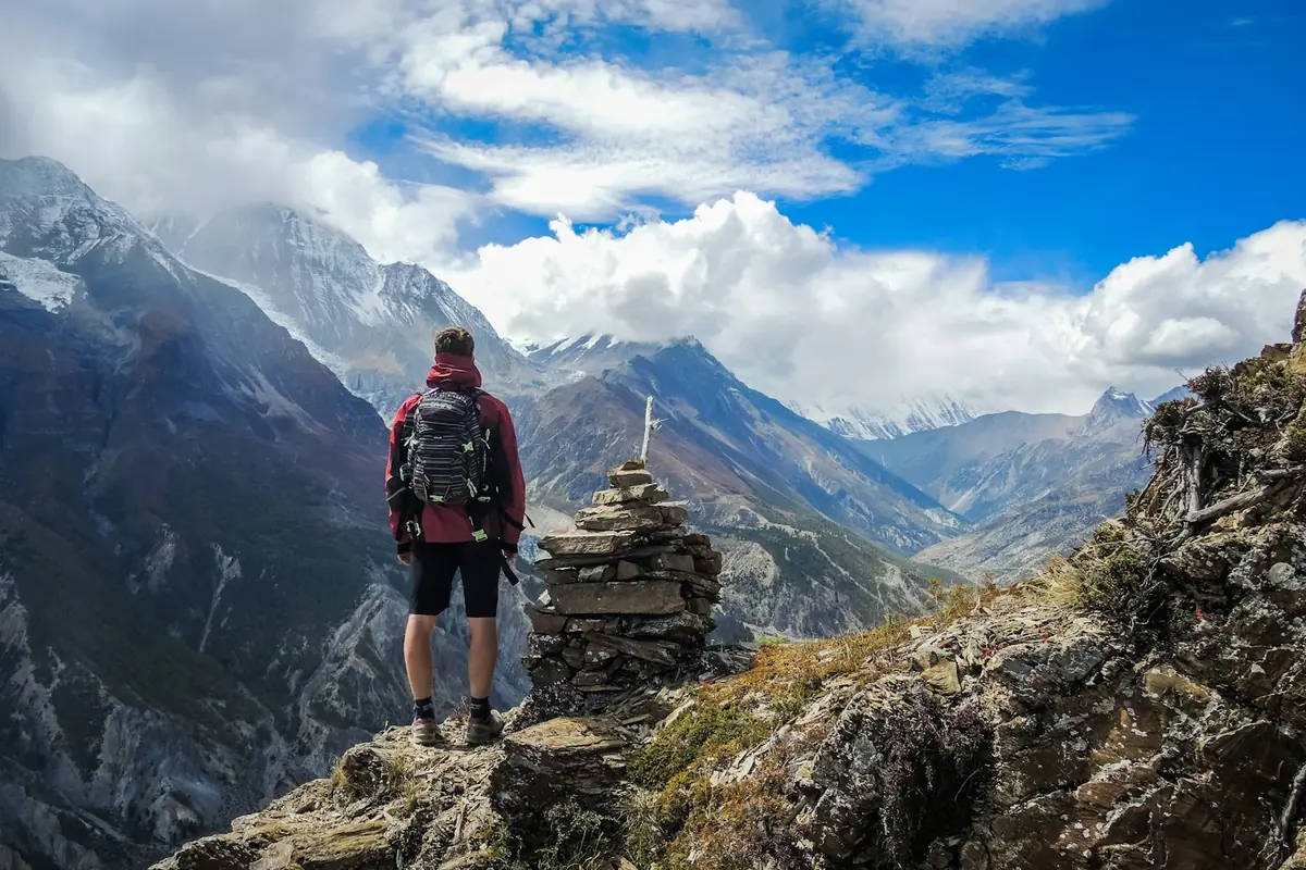 Hiker with a backpack at a mountain viewpoint