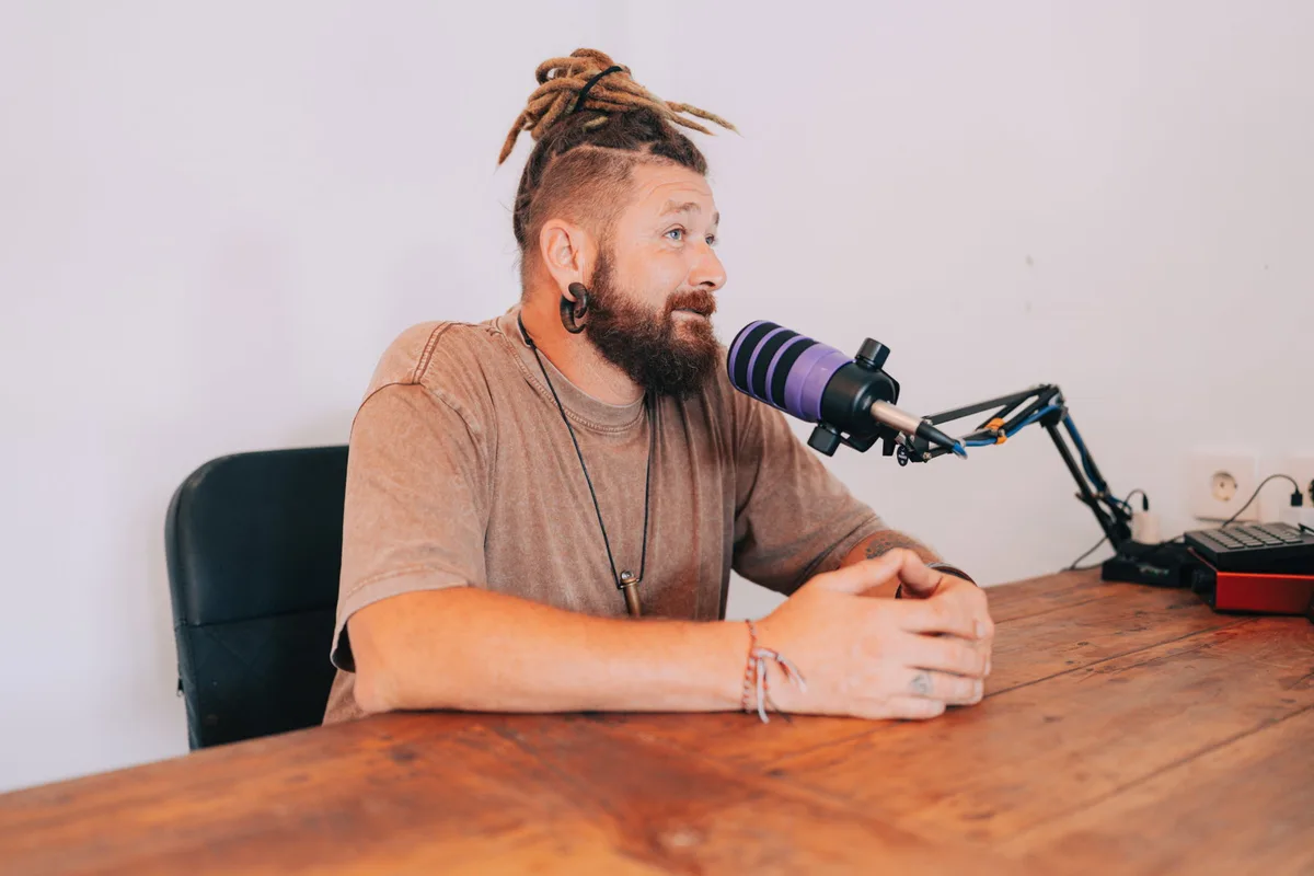 Chenzo recording The Purpose Path Podcast at his microphone