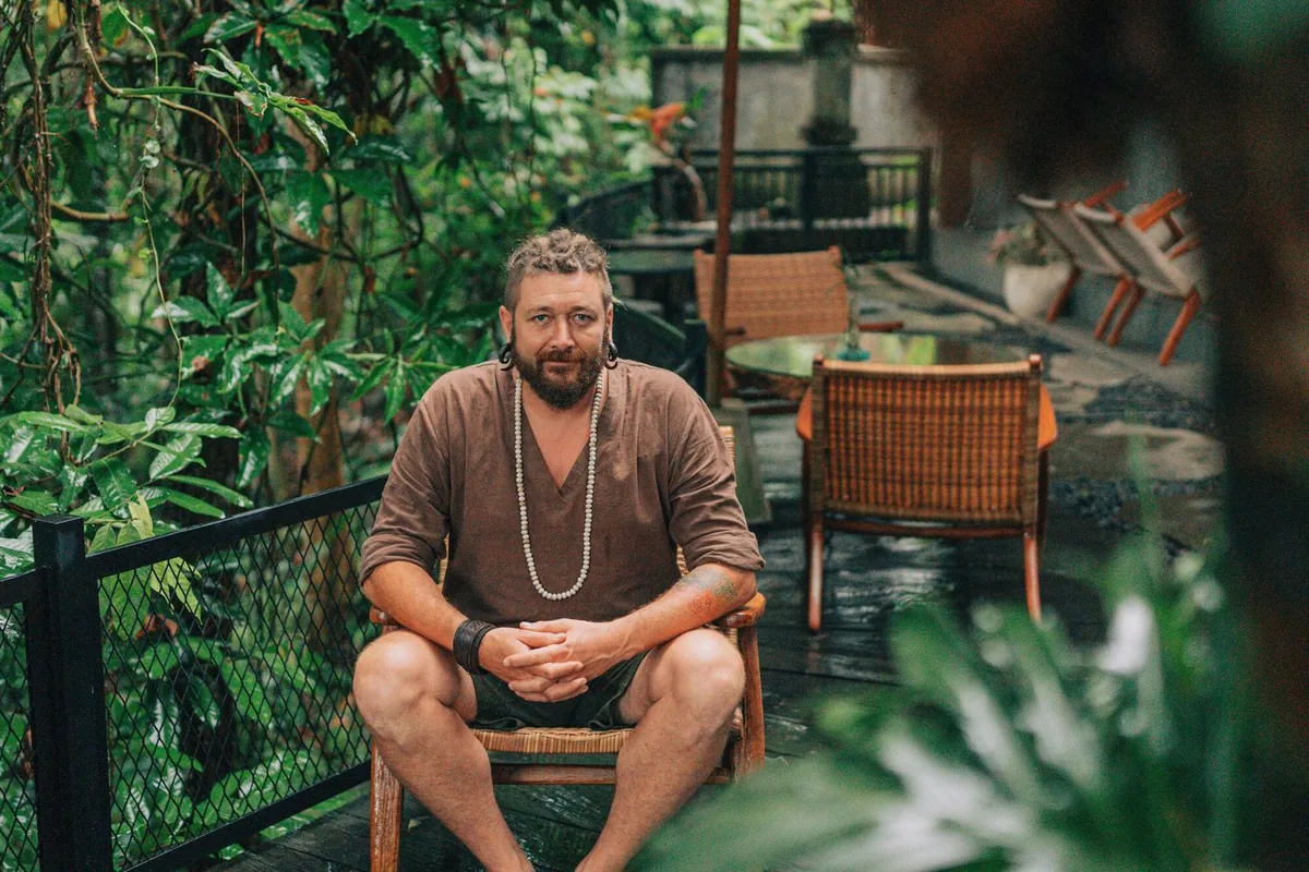 Chenzo, founder of NomadsToolsLab, sitting on a terrace, a spot he would work from