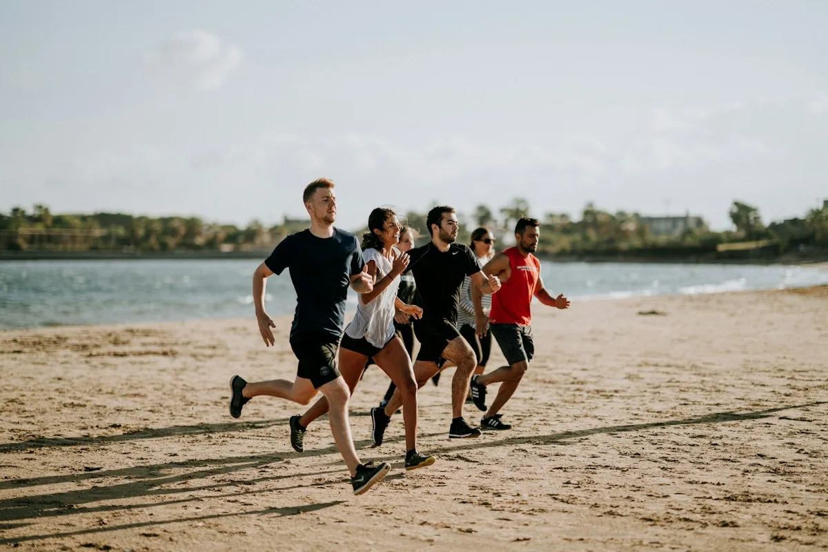 Group of friends on a morning run along the beach, a social life without drinking