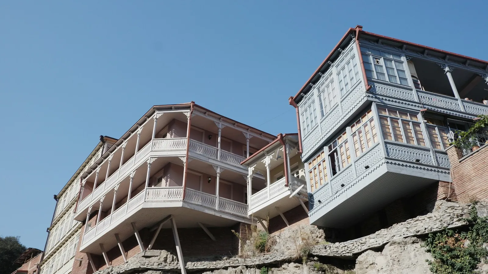 Old houses with wooden balconies on a cliff in Tbilisi old town, Georgia