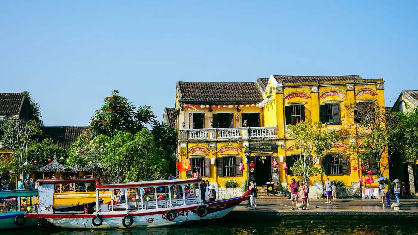 Yellow colonial houses and boats along the river in Hoi An, Vietnam