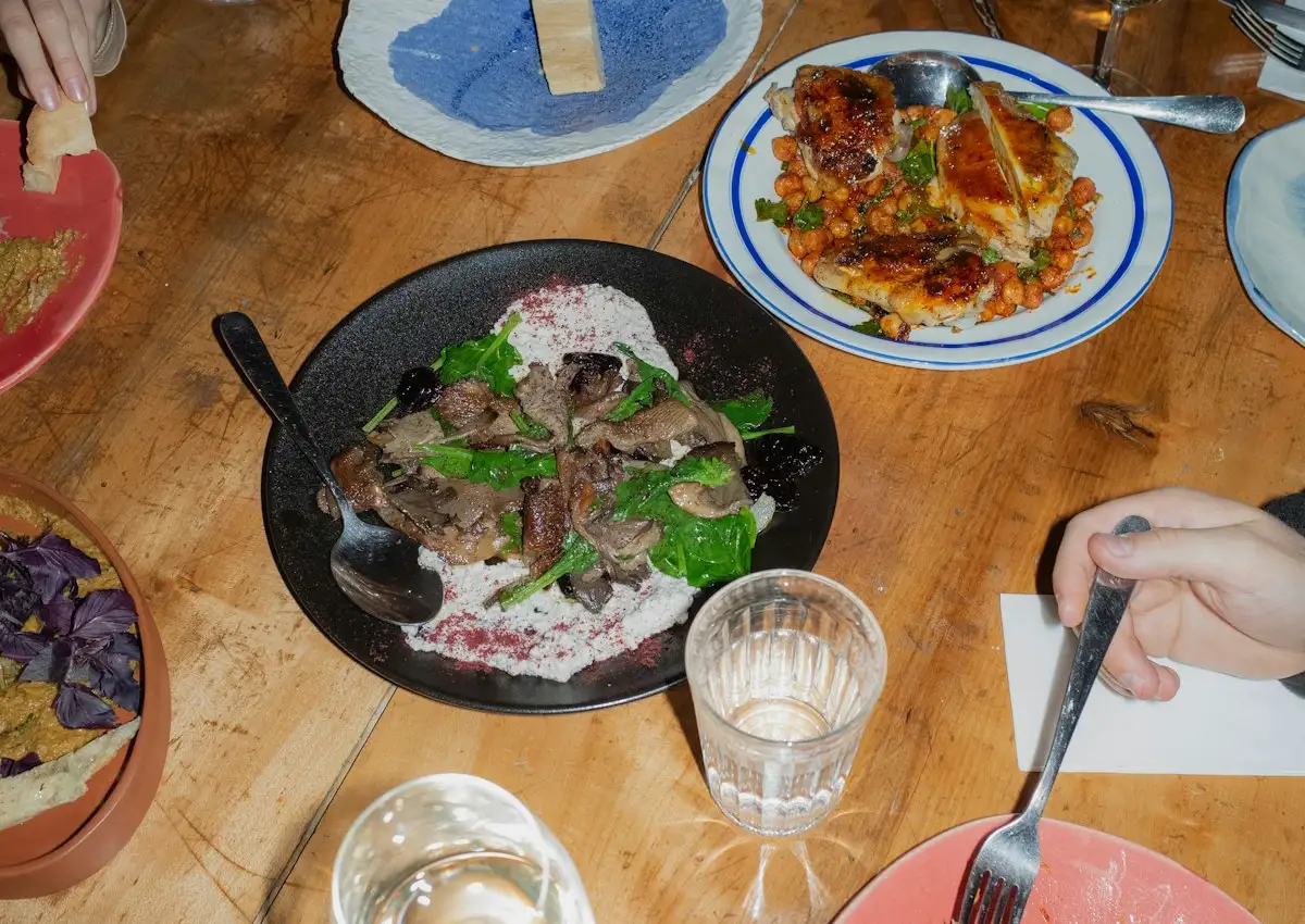 Friends sharing dinner together at a table, a way to beat digital nomad loneliness