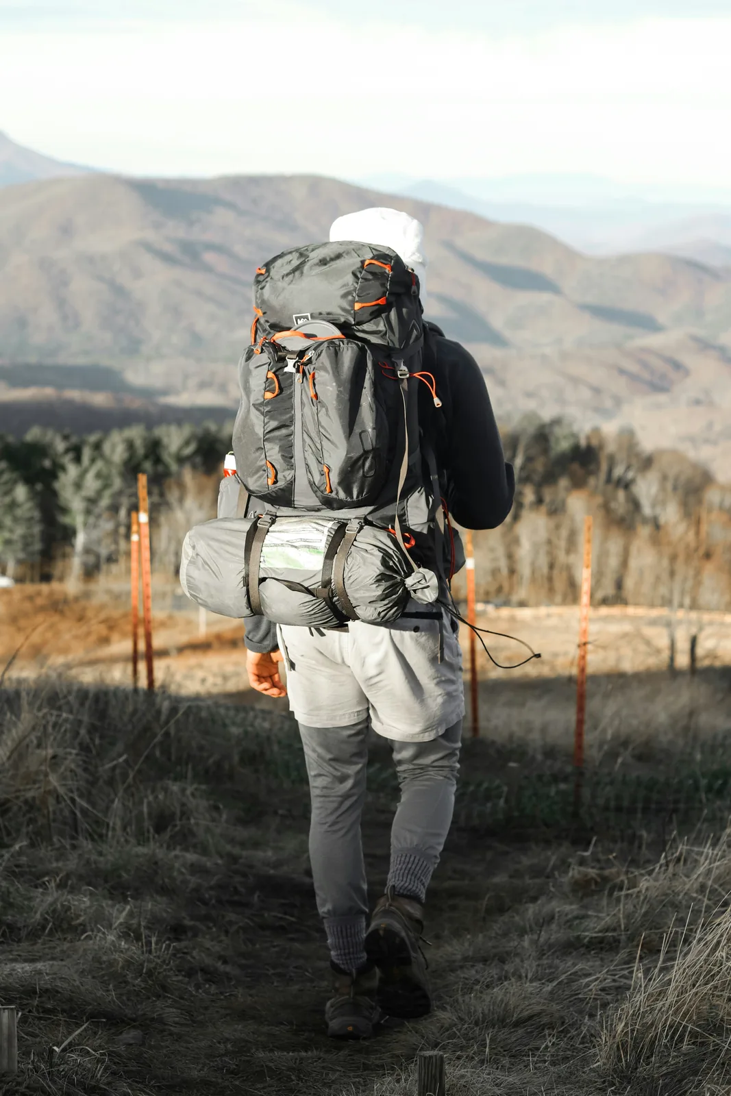 Hiker with a backpack walking a mountain trail