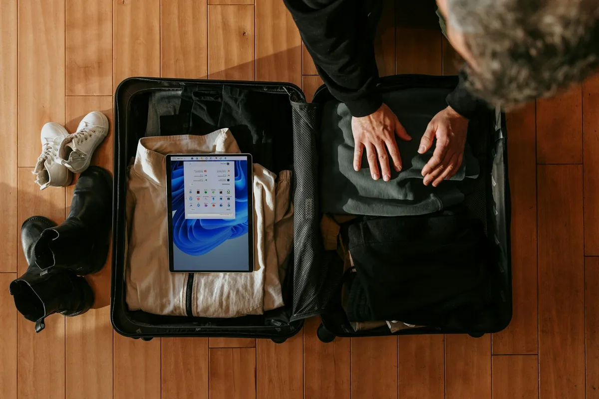 Traveler packing a suitcase for a first trip as a digital nomad