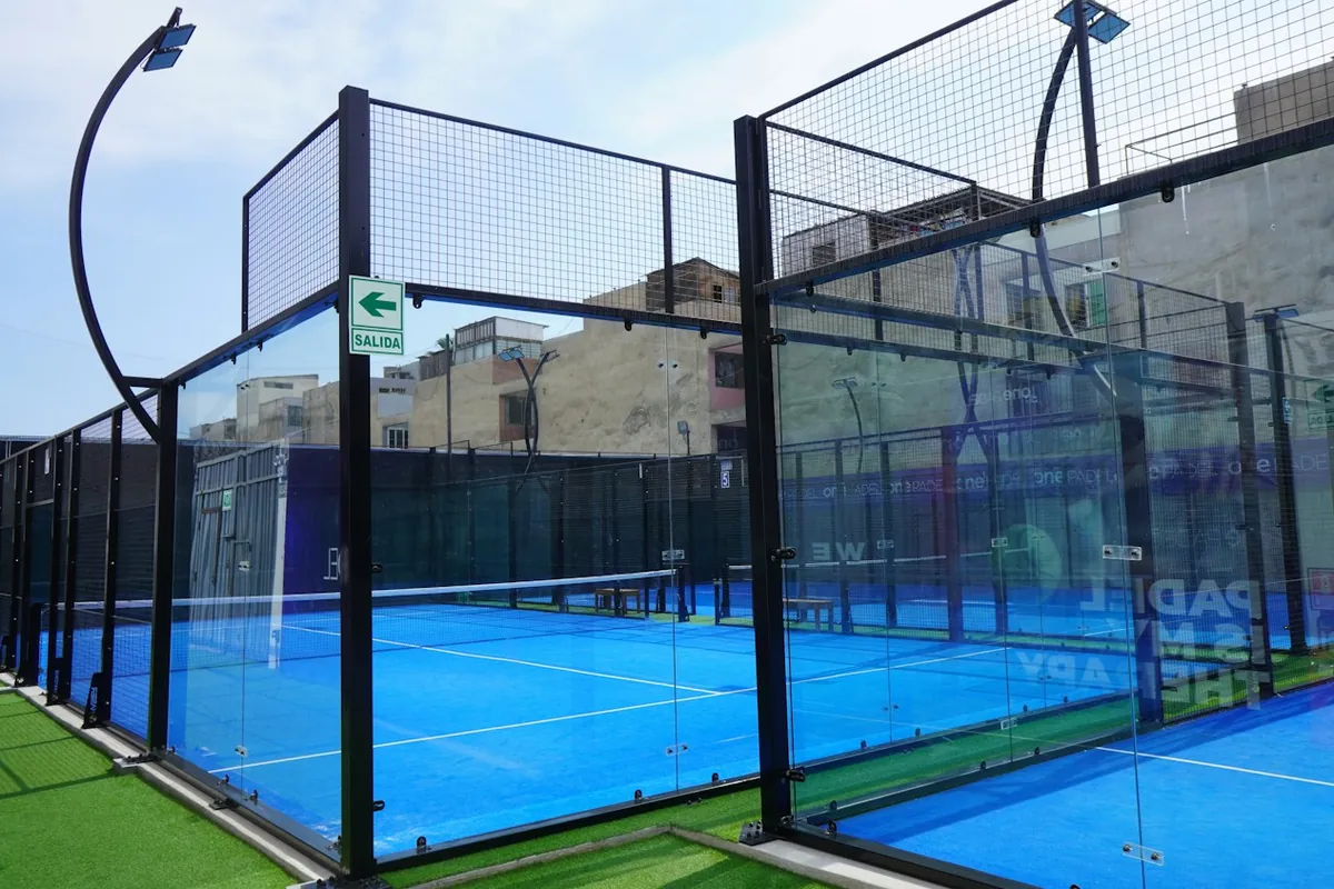 Outdoor padel court with glass walls and fencing