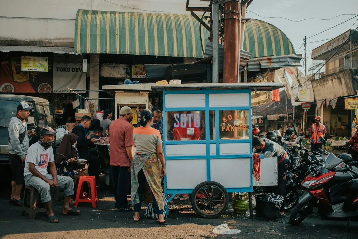 Food stall with locals at a traditional market in Indonesia