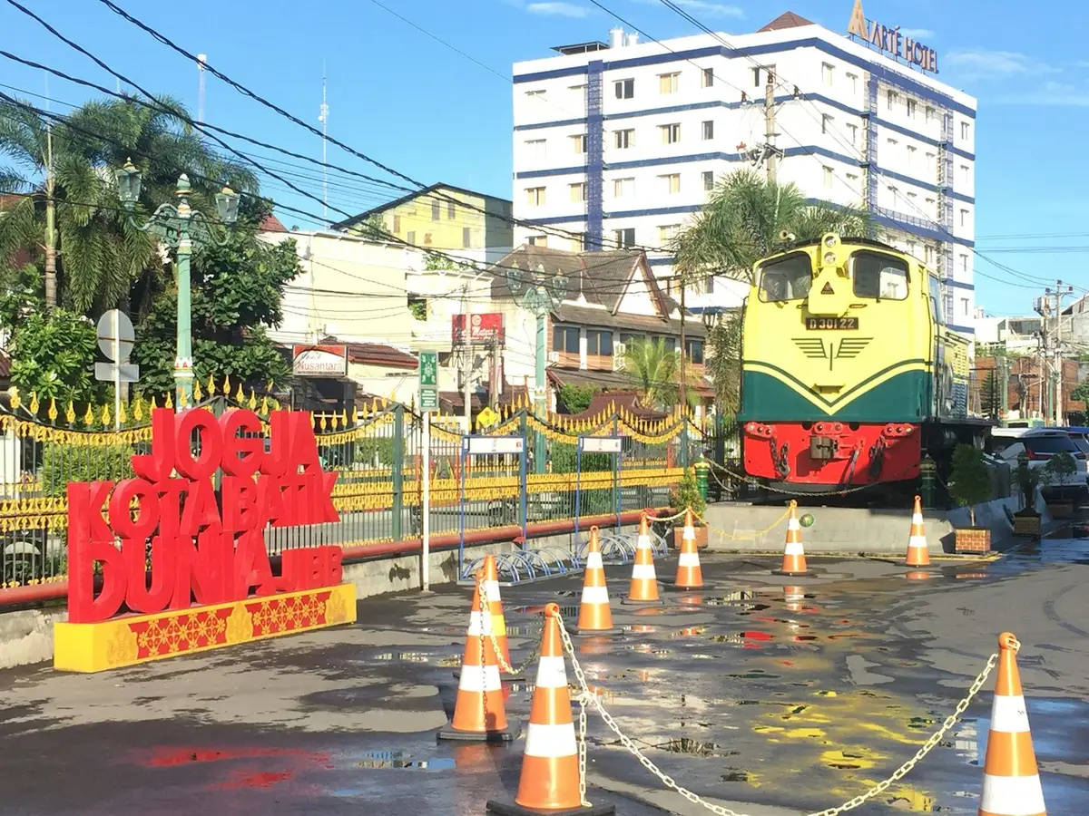 A retired diesel locomotive on display at a railway landmark in Yogyakarta, Indonesia
