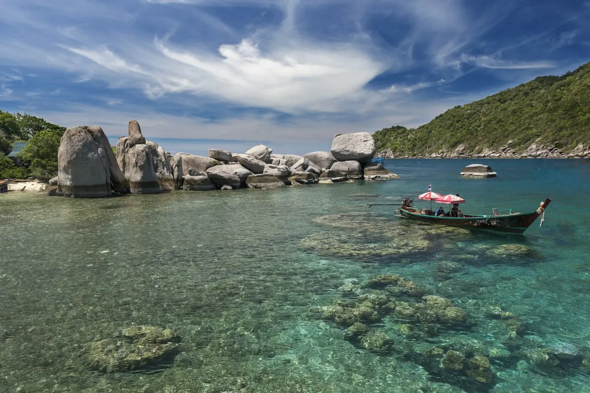 Longtail boat in clear water in the Gulf of Thailand near Koh Phangan, Koh Phangan digital nomad guide