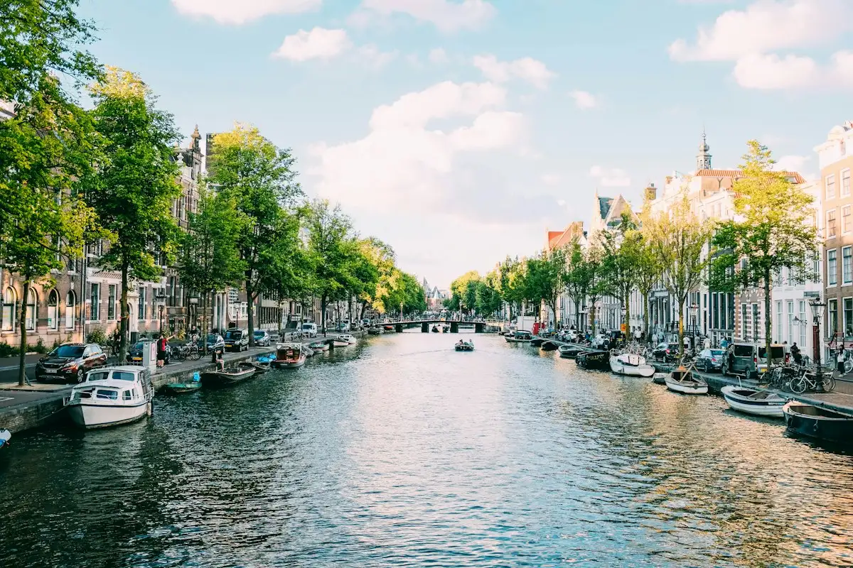 Canal with boats and historic houses in Amsterdam, the Netherlands