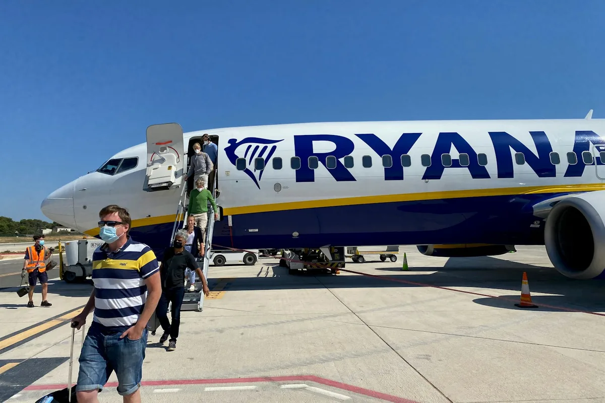 A man standing beside a plane at Palma de Mallorca airport