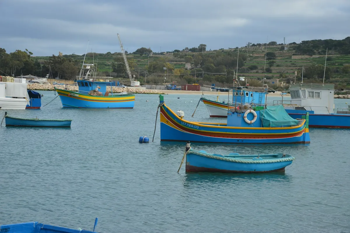Traditional luzzu fishing boats in Marsaxlokk harbour, Malta