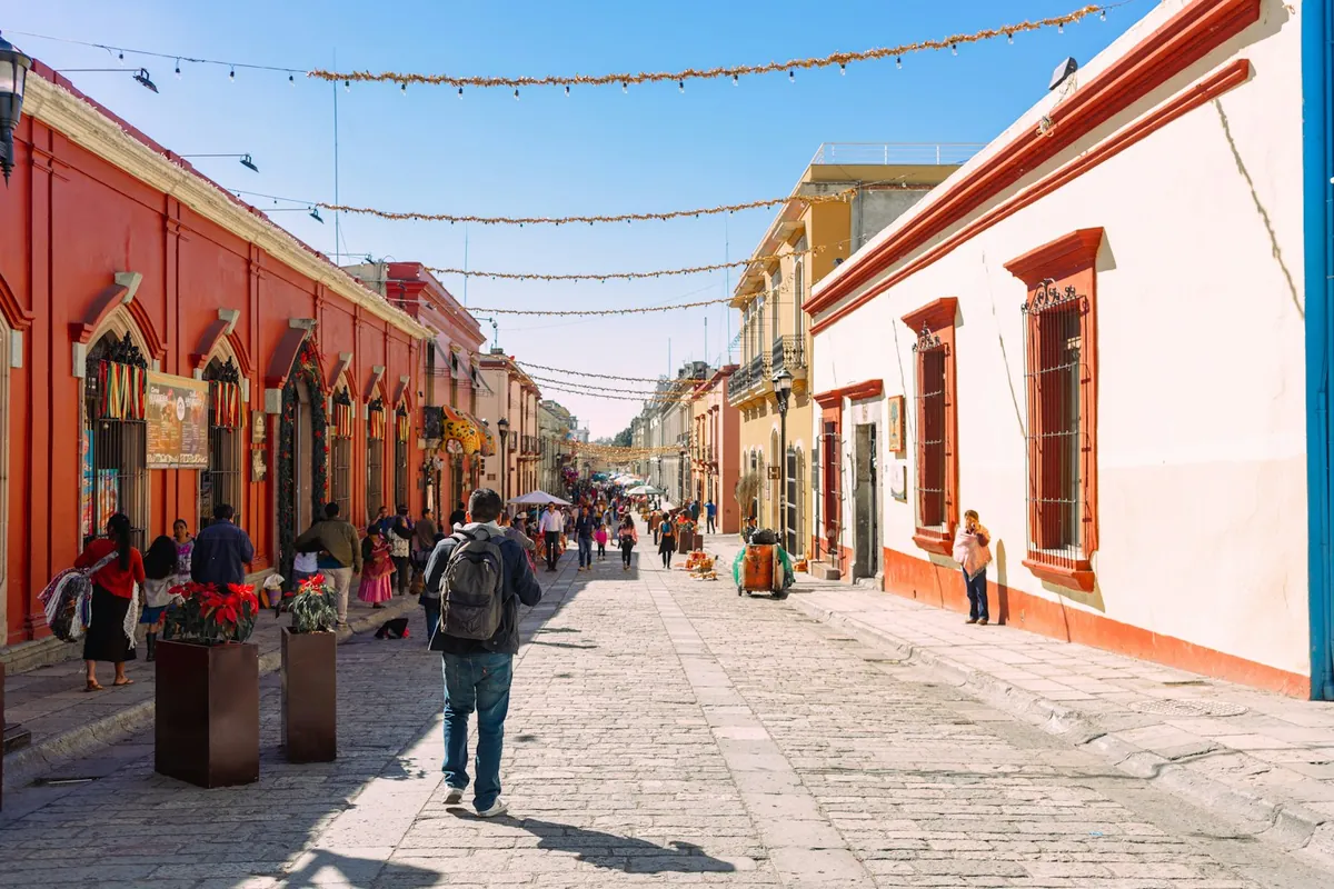 Colorful colonial street with pedestrians in Mexico