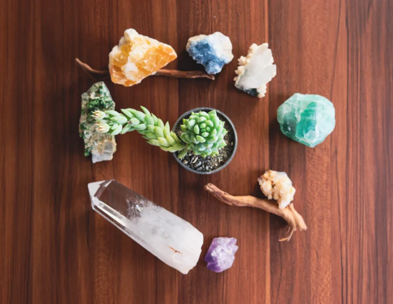 Raw crystals and gemstones arranged on a wooden table