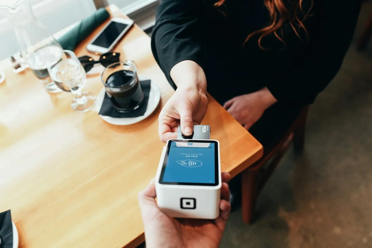 Paying with a card at a cafe card terminal