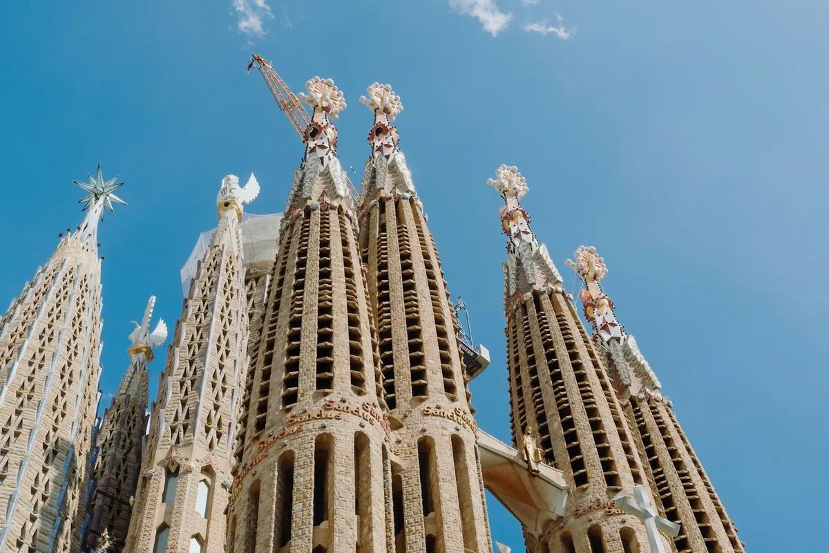 Spires of the Sagrada Familia against a blue sky in Barcelona, Spain
