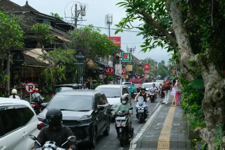 Scooter riding through a busy street in Bali
