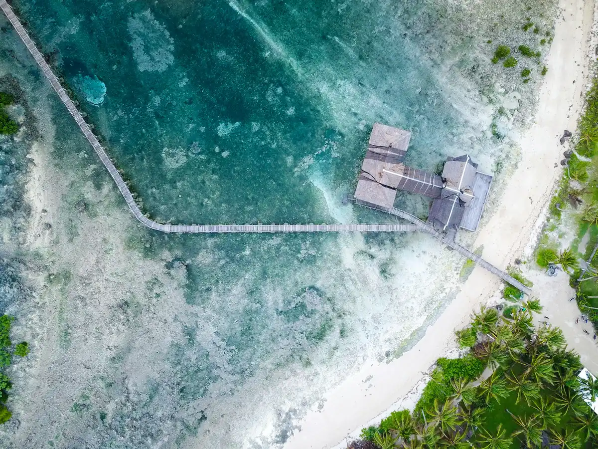 Aerial view of a wooden hut over the reef on Siargao, Siargao digital nomad guide