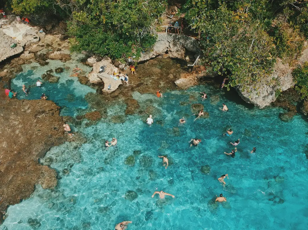 Swimmers in the turquoise Magpupungko rock pools on Siargao