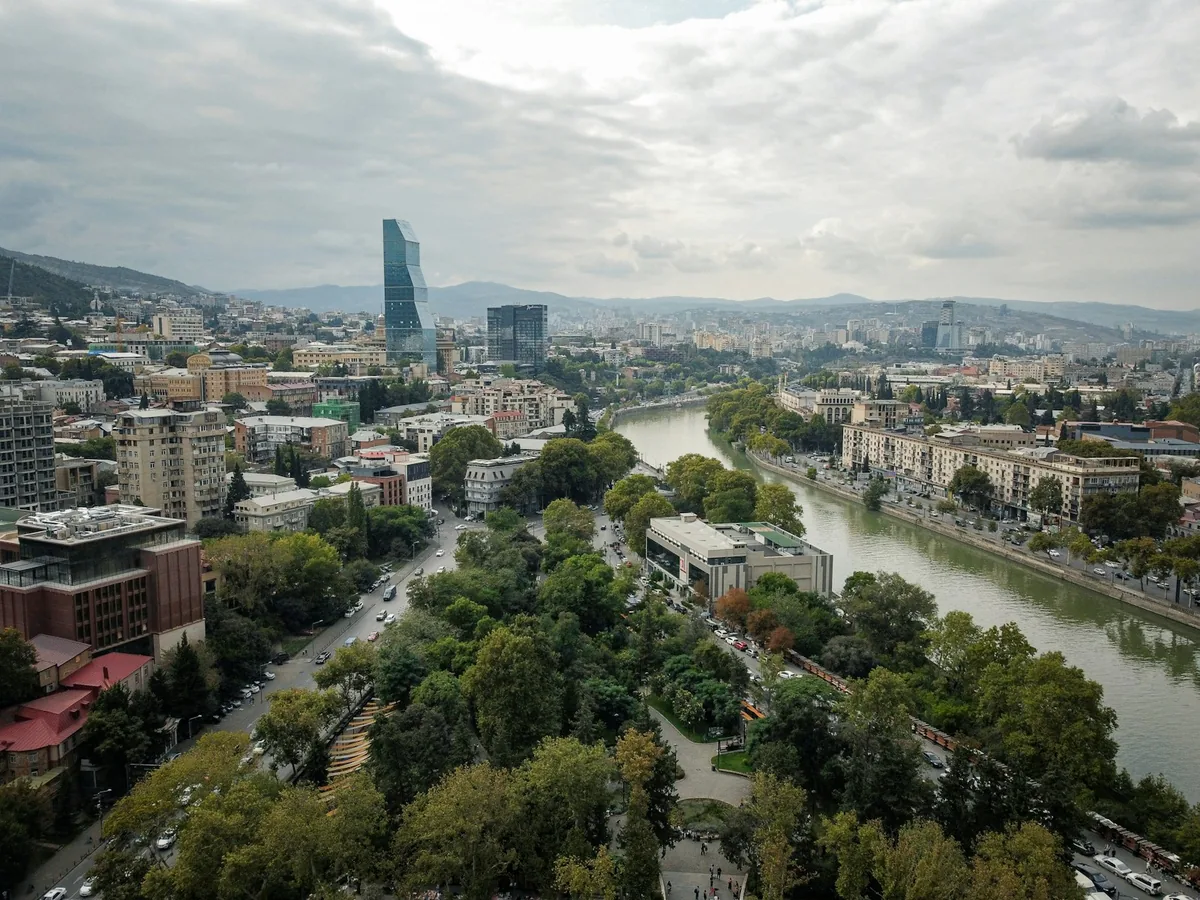 Tbilisi cityscape with the Mtkvari River winding through the valley