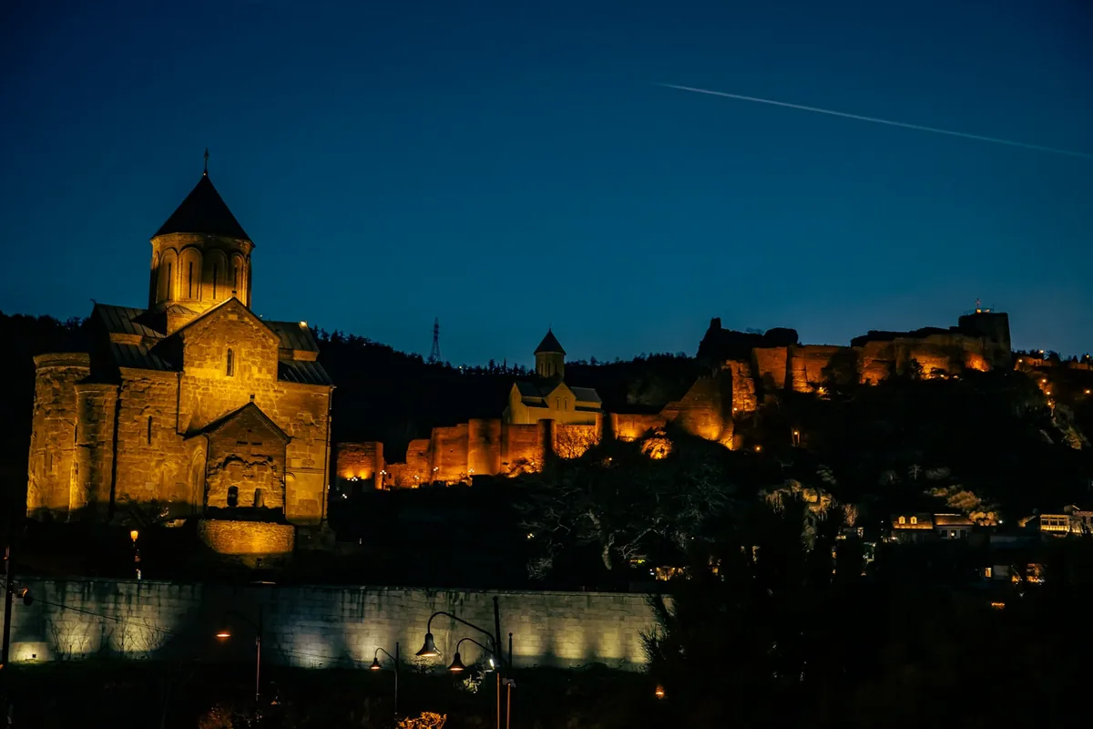 Narikala Fortress lit up above Tbilisi Old Town at night