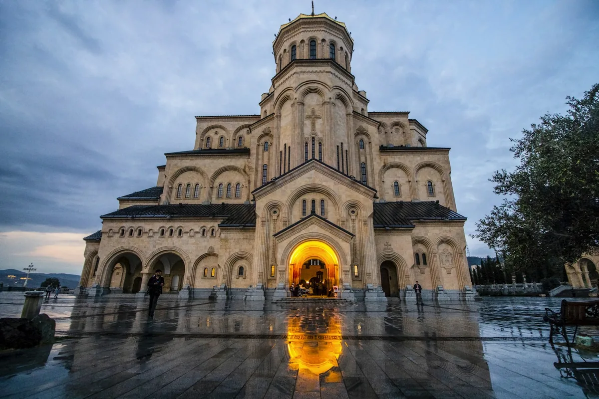 The Holy Trinity Cathedral (Sameba) lit up at dusk in Tbilisi