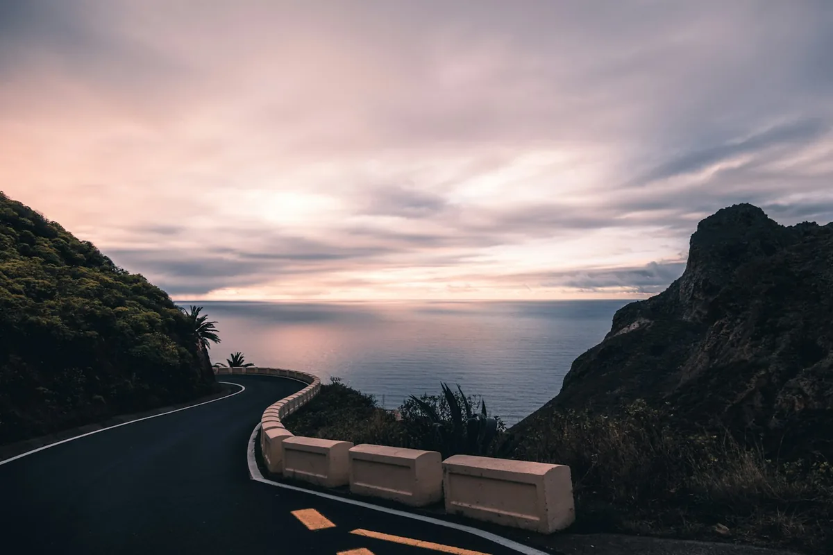 A scenic coastal road on Tenerife at sunset