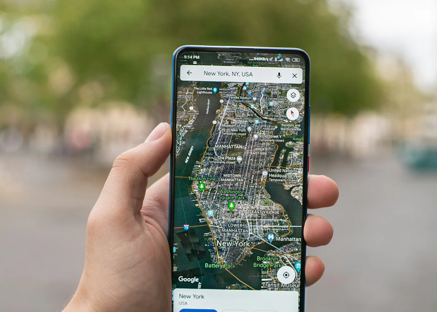 Hand holding an Android phone that shows a city map, like SmartThings Find does for a SmartTag 2