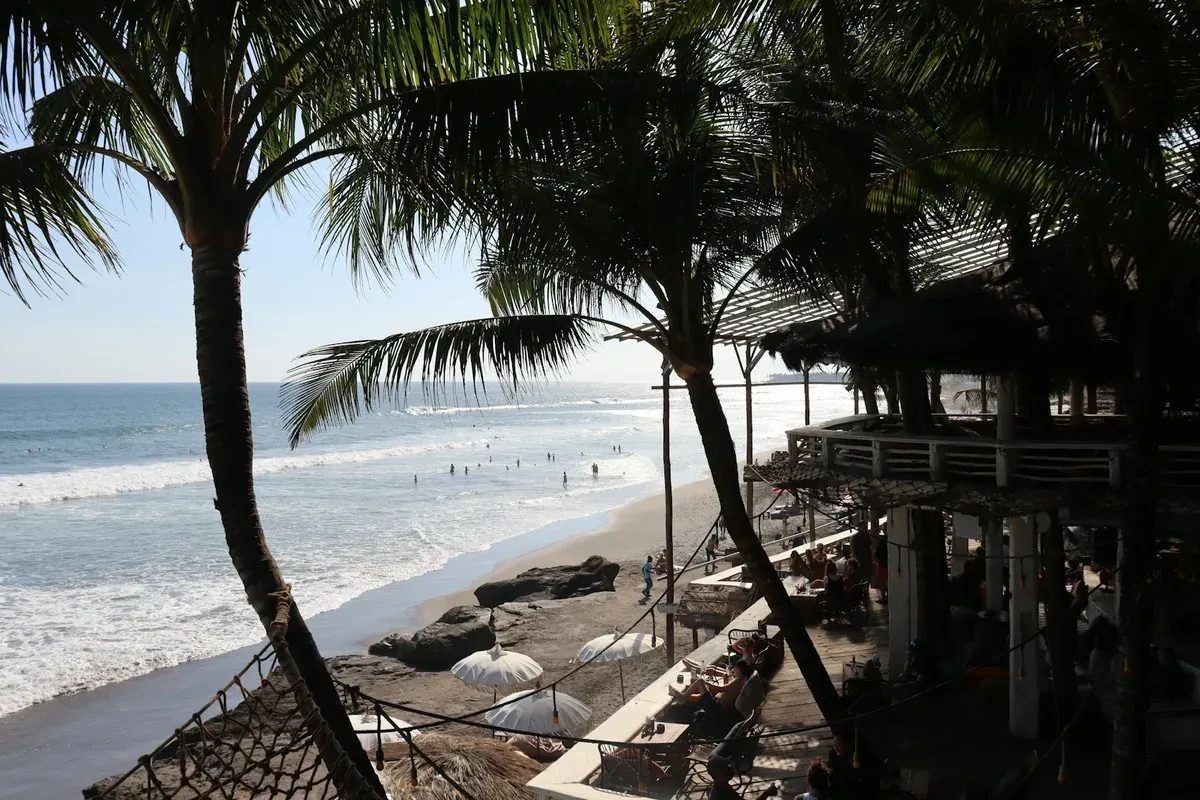 Palm trees and a beach club on the coast in Canggu, Bali, with ATM skimming advice