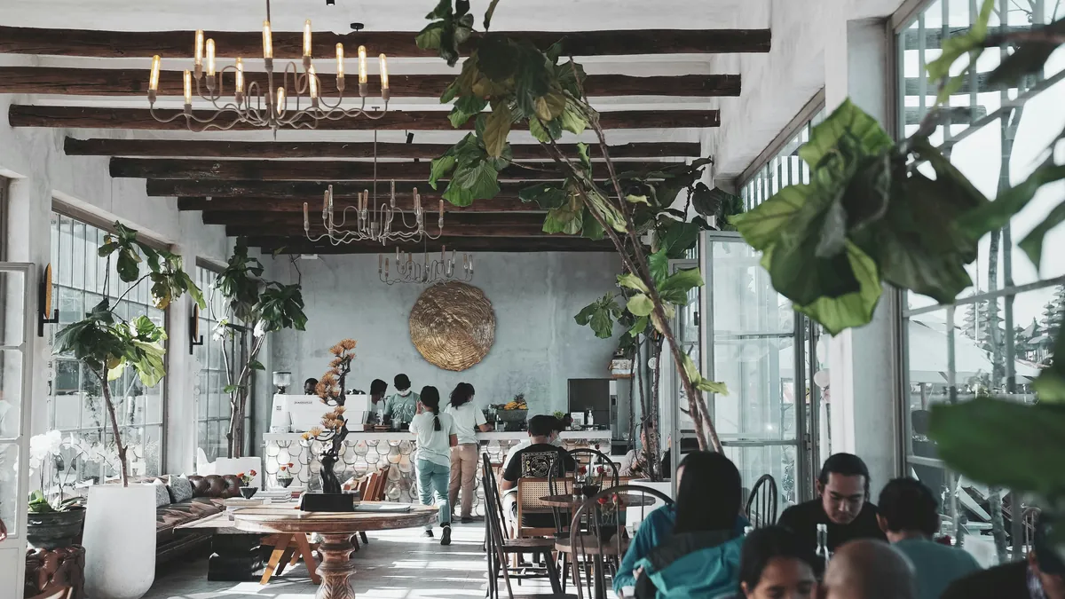 Bright open coworking space with plants and people working, best coworking spaces in Bali