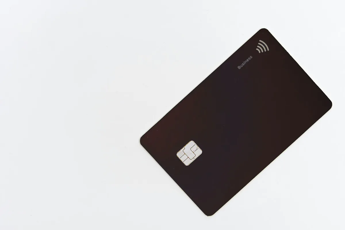 Black bank card with a chip on a white background
