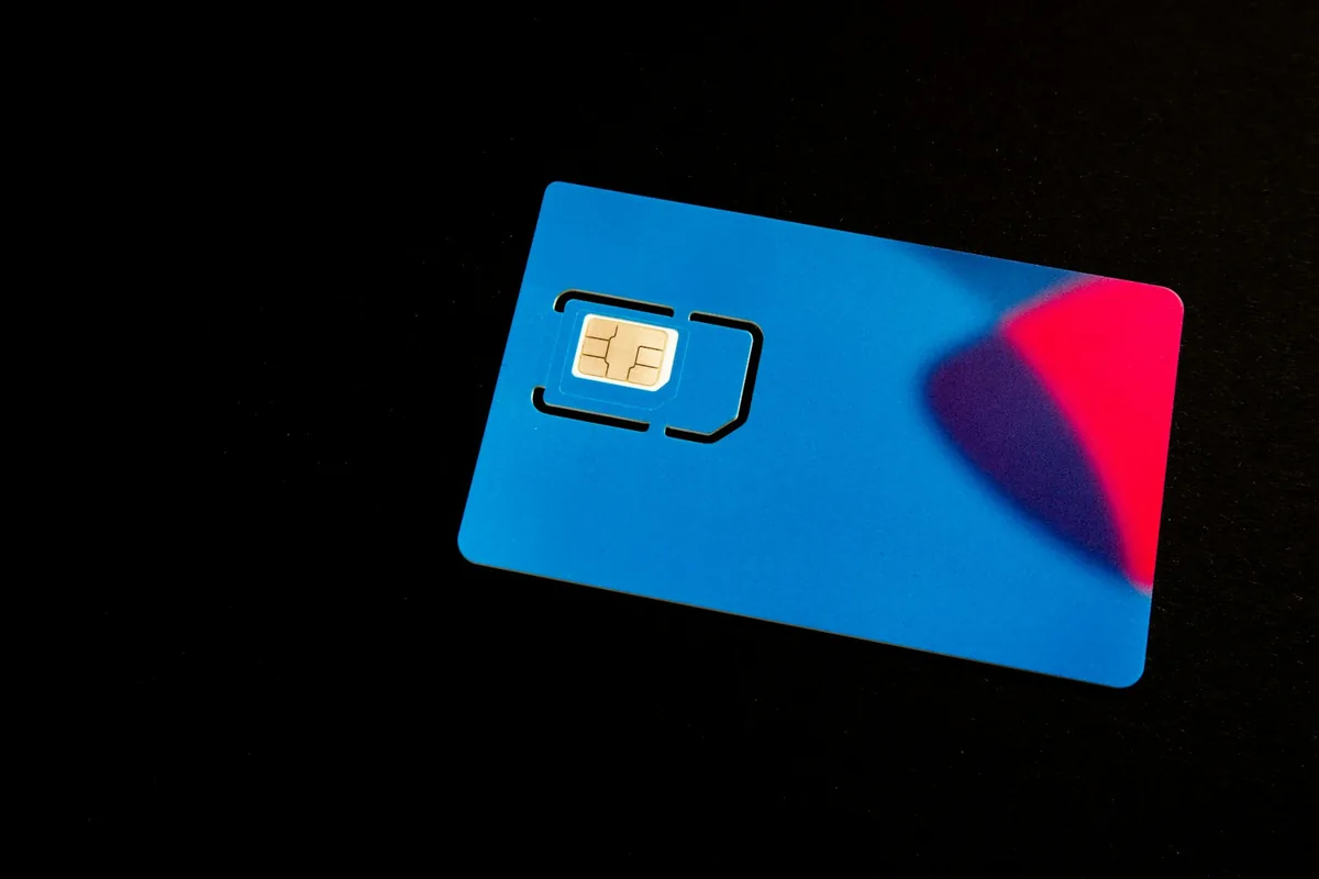 Blue SIM card on a dark surface