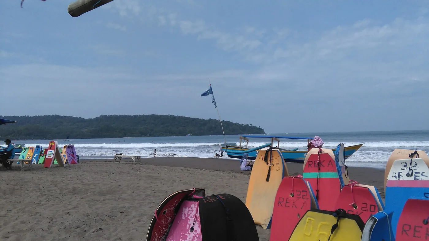 Colorful bodyboards stacked on a beach at Pangandaran, Indonesia