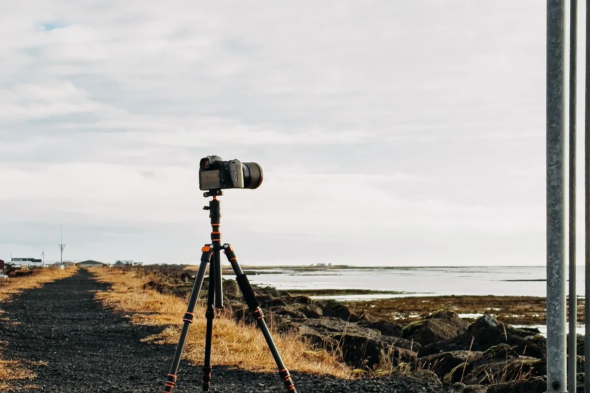 Camera on a tripod on a seaside promenade