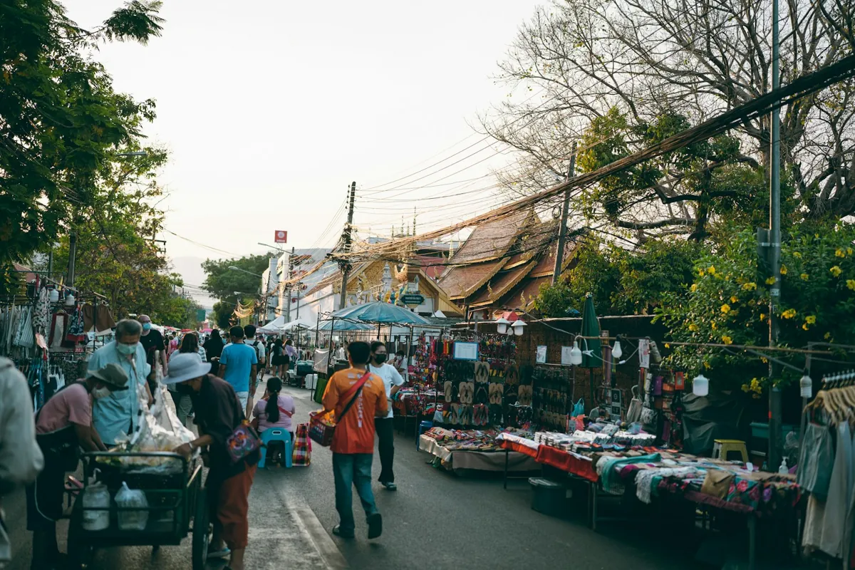 People walking through a street market in Chiang Mai