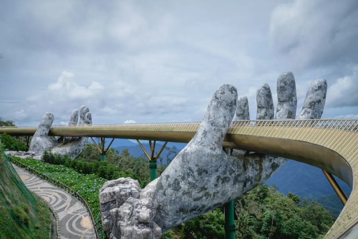 The Golden Bridge held by two giant stone hands at Ba Na Hills near Da Nang