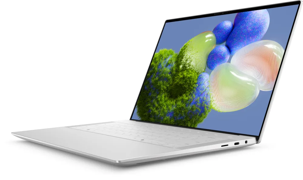 Dell XPS 14 laptop in platinum silver, three-quarter view with a colorful abstract wallpaper on the screen