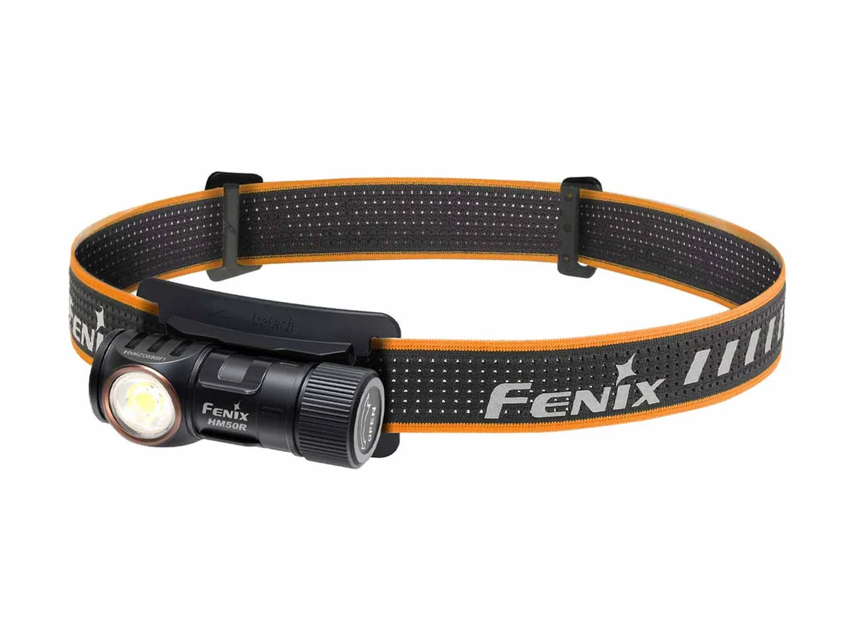 Stirnlampe Fenix HM50R V2.0 auf einem grau-orangen Kopfband