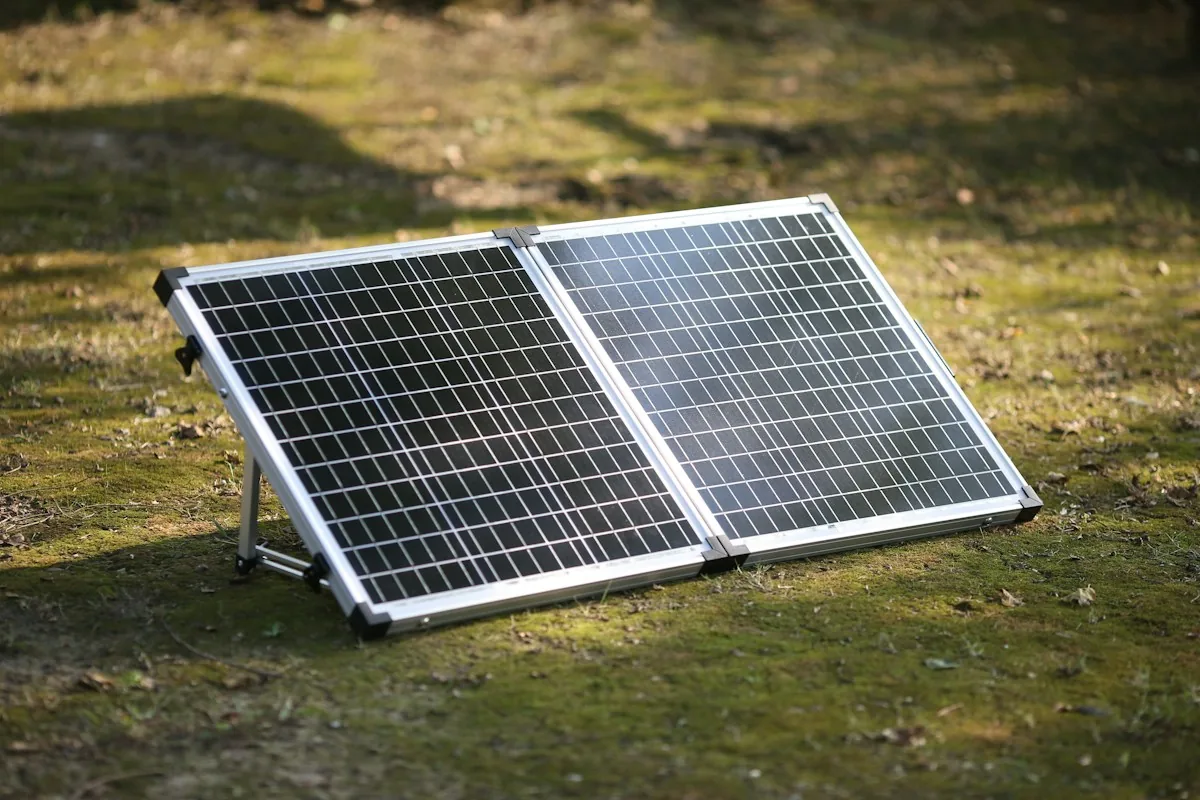 Folding portable solar panel standing on a grass field